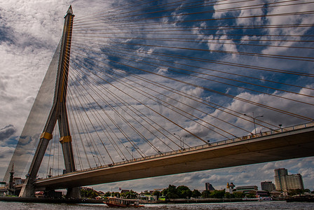 拉玛拉玛八世桥，横跨湄南河的索桥，一座高大的 V 形塔，蓝天景色是曼谷的背景和城市景观。