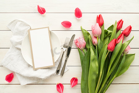 婚礼邀请函装饰摄影照片_优雅的节日餐桌布置，配有花卉装饰和空白菜单卡