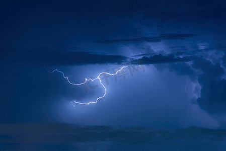 雷阵雨摄影照片_雷暴雷击在夜间乌云密布的天空背景上。