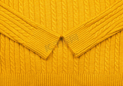 针织衫纹理摄影照片_黄色针织羊毛织物的背景纹理