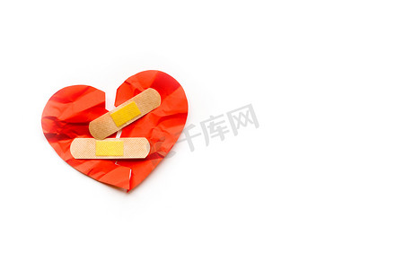 破碎的红心符号与白色背景上的医疗补丁，爱情概念。
