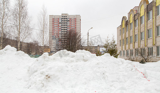 一座大雪堆堆在高楼林立的城市街道上