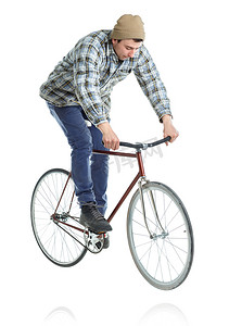 刹车踏板摄影照片_年轻人在白色的自行车上做把戏