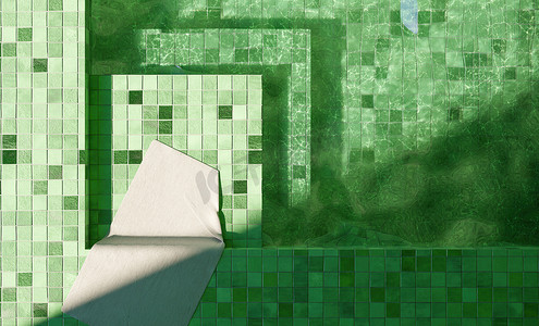 马赛克白背景摄影照片_带白毛巾的绿色瓷砖室内游泳池的顶视图