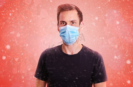 抽象粒子摄影照片_一个戴着病毒面具的男人戴着面具来预防冠状病毒。
