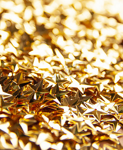 金色五彩纸屑点缀着节日明亮的背景或圣诞节或新年派对装饰