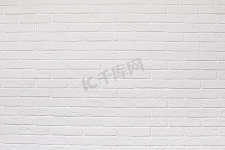 白色砖墙摄影照片_图案背景的白色砖墙纹理。