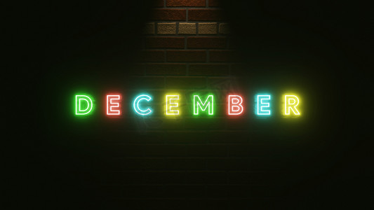 庆祝霓虹灯摄影照片_12 月文本霓虹灯在砖墙纹理上五颜六色。 