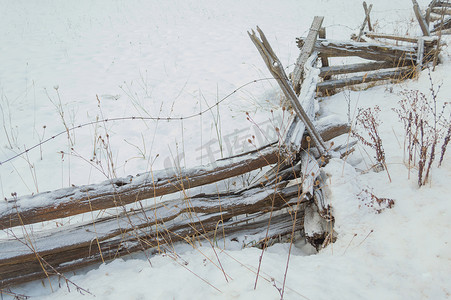 锯齿形质朴的雪松栅栏，上面撒有雪粉