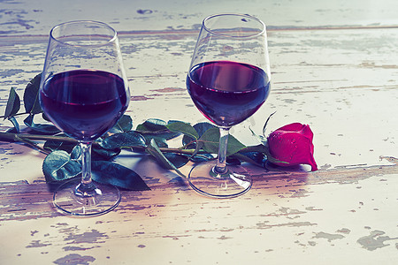 紫色酒杯摄影照片_两杯酒和一朵红玫瑰