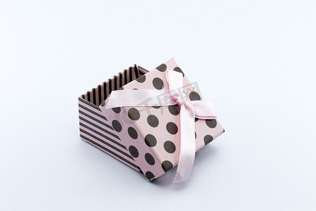 粉色礼品盒摄影照片_粉色礼品盒在白色背景下被打开。