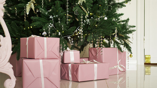 圣诞树下有丝带的粉色礼物盒