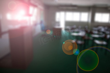 绿色会议背景板摄影照片_大教室里的椅子模糊了镜头光晕背景