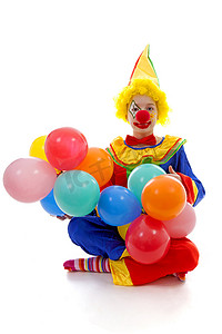 小丑气球摄影照片_孩子装扮成五颜六色的滑稽小丑，拿着气球