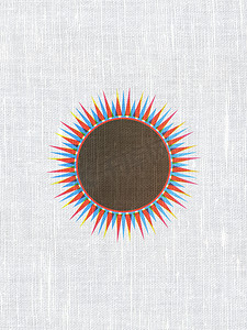 太阳图标摄影照片_旅游概念： 织物纹理背景上的太阳