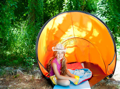 在户外森林帐篷里带帽子的露营儿童女孩