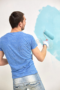 家里有蓝色滚筒画墙的男人