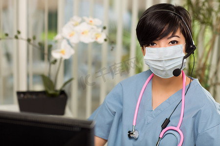 护士台摄影照片_戴着医用口罩的办公桌护士