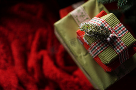毯红摄影照片_圣诞树下漂亮的圣诞绿色礼盒，铺着红毯