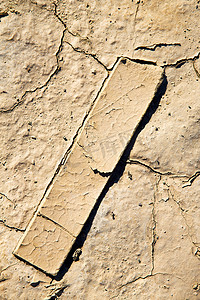 不在地球摄影照片_在木头和抽象的棕色干沙子