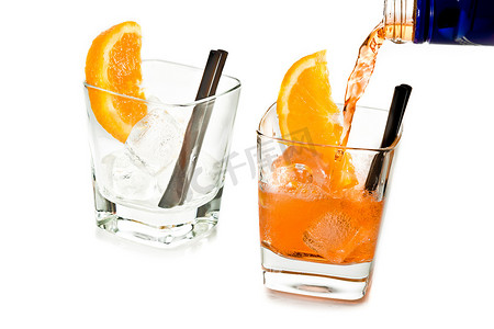 酒广告摄影照片_酒保将 spritz 开胃酒 aperol 鸡尾酒倒在两杯橙片和冰块中