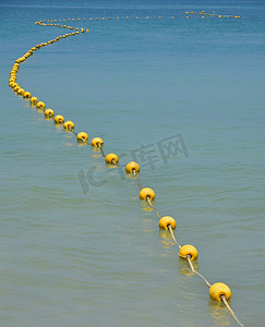 蓝色海水中的黄色浮标链