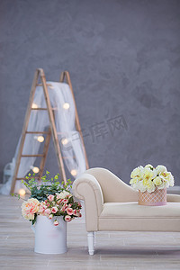工作室室内装饰，浅色暖色鲜花和休闲复古家具