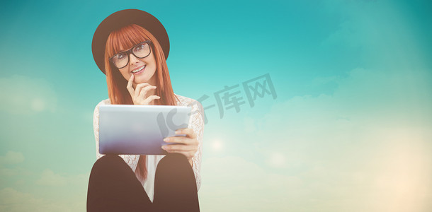 微笑的时髦女人使用她的平板电脑的合成图像