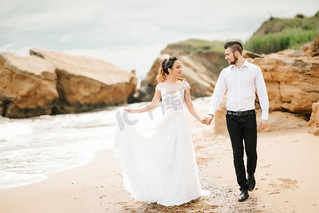 新郎与新娘摄影照片_年轻夫妇新郎与新娘在沙滩上