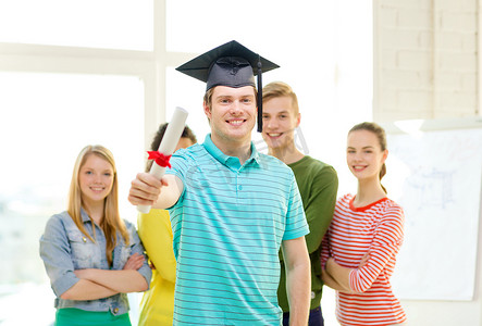 黄色五角星边框摄影照片_拿着文凭和角帽的微笑男学生