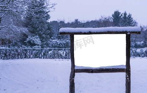 白雪覆盖的空白木制广告牌，冬季森林，宣传广告牌