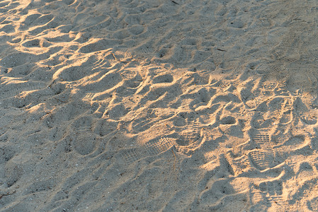 夏季沙滩沙纹与日出光束的特写