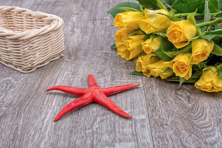 海星图案摄影照片_木制背景中的红海星和玫瑰