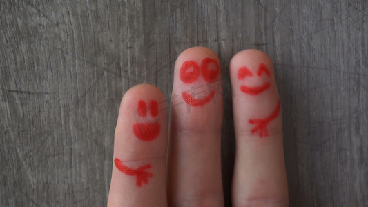 Happy fingers.beautiful faces painted on the toes