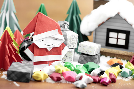 闪动小星星摄影照片_雪地上有小星纸的圣诞老人和礼盒