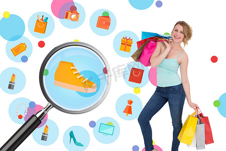 生活购物图标摄影照片_微笑的金发女人拿着购物袋站着的合成图像