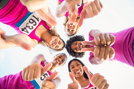 已调音摄影照片_五位微笑的跑步者支持乳腺癌马拉松