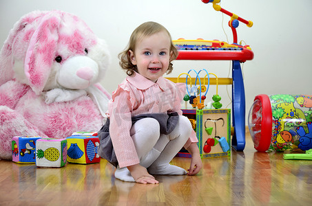立方体的兔子摄影照片_房间里的小女孩有玩具
