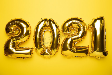 黄色金箔摄影照片_黄色背景的金箔气球2021年新年