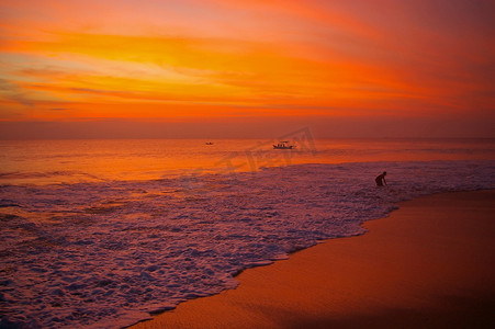 夕阳下的人摄影照片_夕阳下的巴厘岛海滩