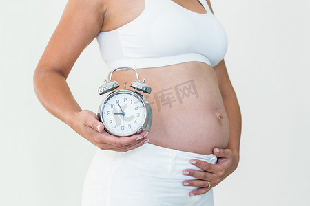 颠簸摄影照片_显示时钟和颠簸的孕妇
