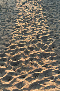 夏季沙滩沙纹与日出光束的特写