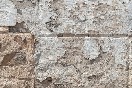 地理碎裂摄影照片_灰色质地，混凝土墙上的旧碎石膏，背景