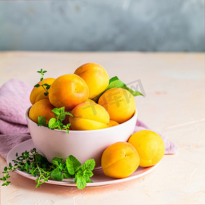 粉色碗中的新鲜甜橙杏