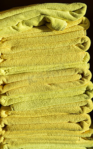 堆摄影照片_阳光照射在一堆黄色浴巾上
