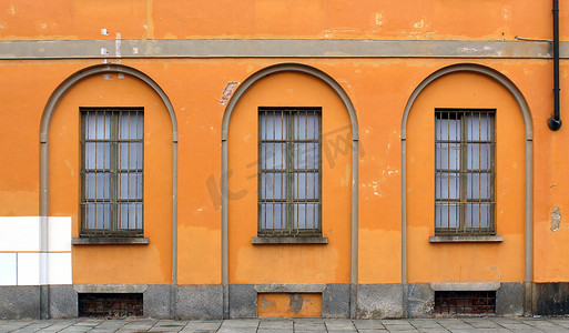 赭石摄影照片_橙色赭石墙上的窗栏和关闭的窗户