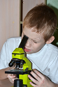 这个男孩在显微镜下看