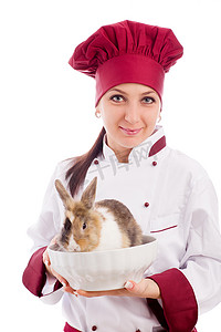 赶车鞭子摄影照片_厨师在碗里放着侏儒兔