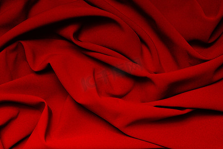 红色褶皱摄影照片_鲜红色布料的褶皱。