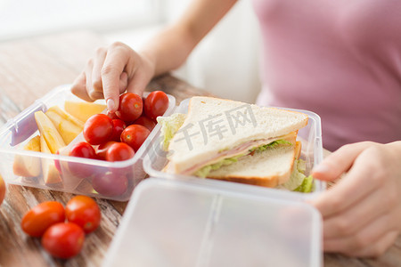 女人用塑料容器装食物的特写